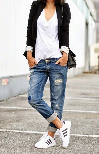 Черный пиджак и синие рваные джинсы-бойфренды — must have вещи в стильном женском гардеробе. Если ты не боишься экспериментировать, на ноги можно надеть белая обувь.